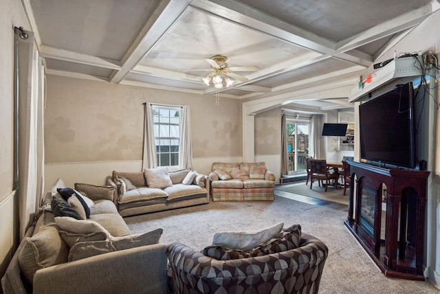 704 N Jefferson St, Mexico, MO 65265 - carpeted living area featuring coffered ceiling, wainscoting, beam ceiling, ceiling fan, and arched walkways