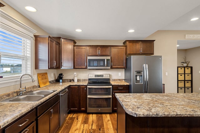 4969 W Red Tail Dr, Ashland, MO 65010 - kitchen with stainless steel appliances, light wood finished floors, recessed lighting, and dark brown cabinets