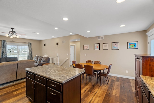4969 W Red Tail Dr, Ashland, MO 65010 - kitchen with dark wood finished floors, a ceiling fan, dark brown cabinetry, recessed lighting, and a center island