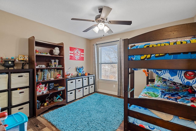 4969 W Red Tail Dr, Ashland, MO 65010 - bedroom with wood finished floors, a ceiling fan, and a textured ceiling