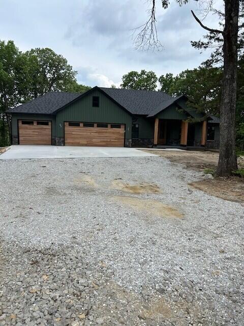 13265 N Old Number 7, Columbia, MO 65202 - view of front facade featuring driveway, a garage, and roof with shingles