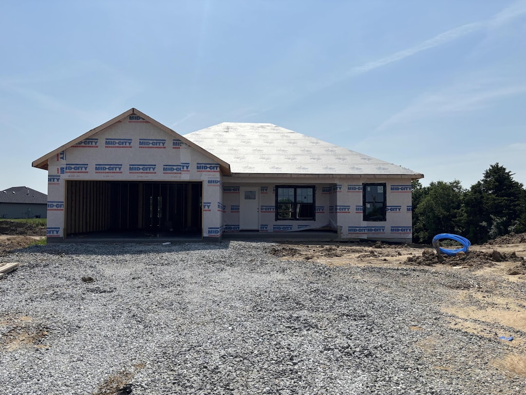 5724 Blackgum Ct, Columbia, MO 65202 - unfinished property featuring an attached garage and gravel driveway