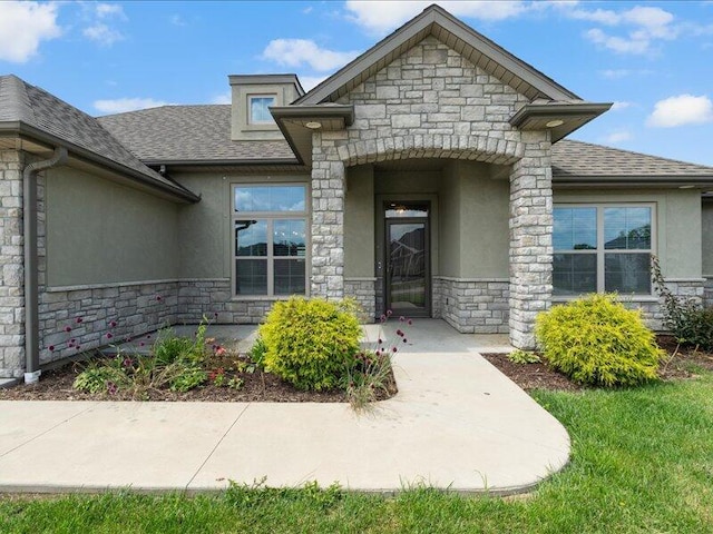 5204 Newbury Way, Columbia, MO 65203 - doorway to property featuring stone siding, stucco siding, and roof with shingles