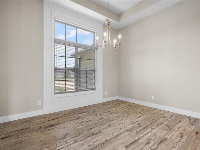 5204 Newbury Way, Columbia, MO 65203 - empty room featuring wood finished floors and a chandelier