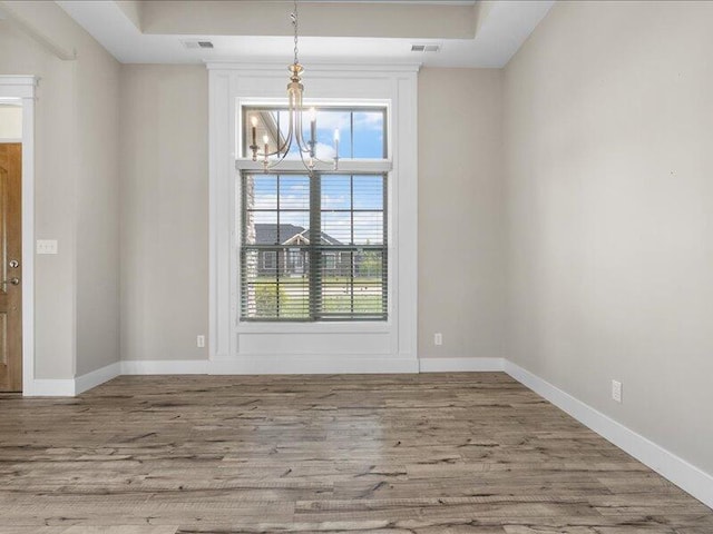 5204 Newbury Way, Columbia, MO 65203 - unfurnished dining area with a chandelier, plenty of natural light, and wood finished floors
