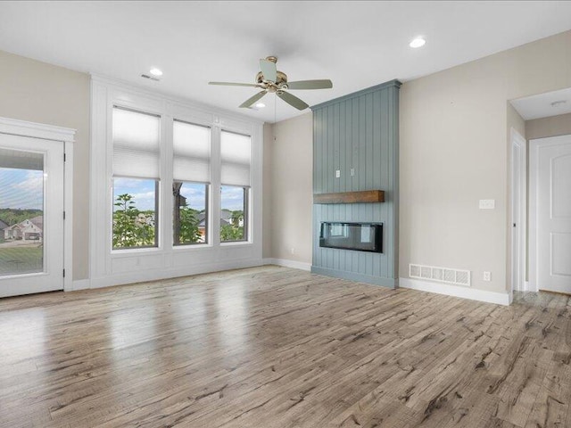 5204 Newbury Way, Columbia, MO 65203 - unfurnished living room featuring wood finished floors, ceiling fan, a fireplace, and recessed lighting