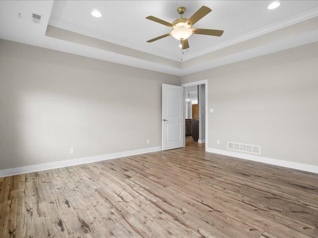 5204 Newbury Way, Columbia, MO 65203 - spare room featuring a raised ceiling, wood finished floors, crown molding, ceiling fan, and recessed lighting