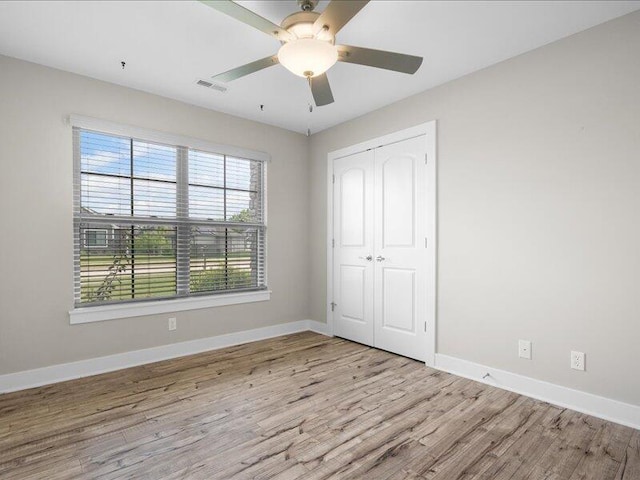 5204 Newbury Way, Columbia, MO 65203 - unfurnished bedroom featuring wood finished floors, a closet, and ceiling fan