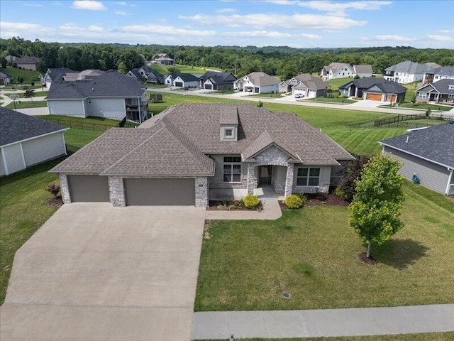 5204 Newbury Way, Columbia, MO 65203 - view of front of property featuring stone siding, an attached garage, a residential view, driveway, and a front yard