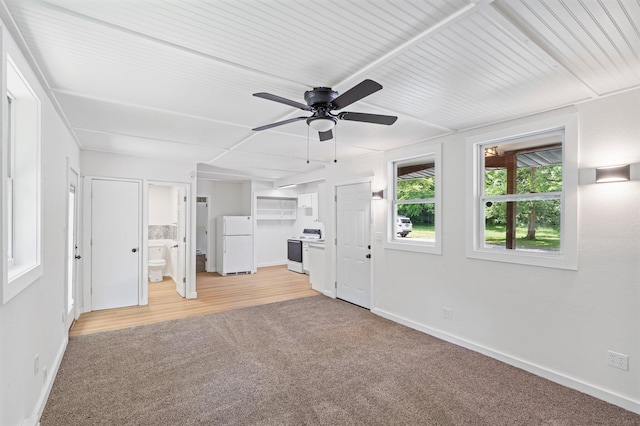 504 1st St, Boonville, MO 65233 - unfurnished living room featuring light carpet and ceiling fan