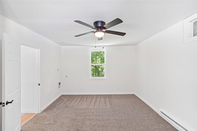 504 1st St, Boonville, MO 65233 - spare room featuring a baseboard heating unit, ceiling fan, and light colored carpet