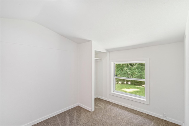 504 1st St, Boonville, MO 65233 - carpeted spare room featuring lofted ceiling and baseboards