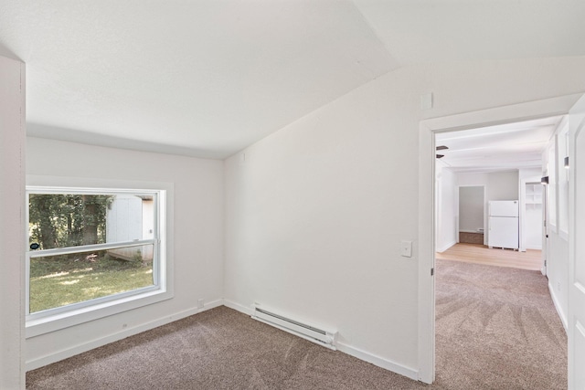 504 1st St, Boonville, MO 65233 - carpeted spare room featuring baseboard heating and vaulted ceiling