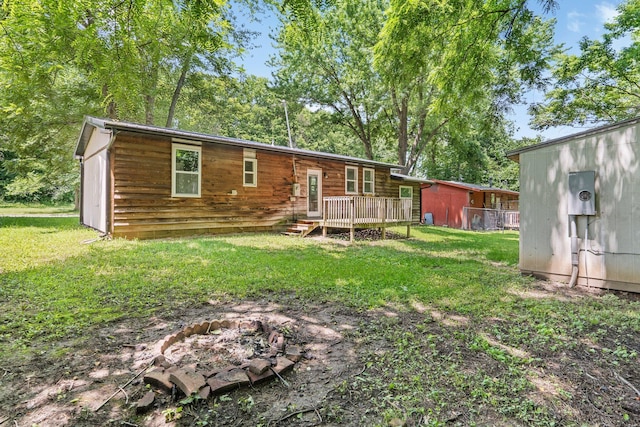 504 1st St, Boonville, MO 65233 - back of property with an outdoor fire pit, a wooden deck, and a yard