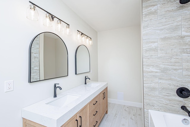 902 S Cedar Grove Blvd, Columbia, MO 65201 - bathroom featuring double vanity, wood finished floors, and tub / shower combination