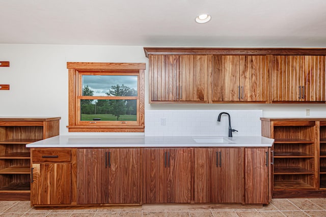 902 S Cedar Grove Blvd, Columbia, MO 65201 - kitchen featuring light countertops, backsplash, brown cabinetry, and recessed lighting