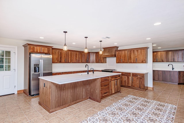 902 S Cedar Grove Blvd, Columbia, MO 65201 - kitchen with stainless steel fridge, recessed lighting, light countertops, a kitchen island with sink, and light tile patterned floors