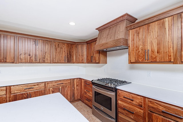 902 S Cedar Grove Blvd, Columbia, MO 65201 - kitchen with stainless steel range with gas stovetop, backsplash, light countertops, brown cabinetry, and recessed lighting