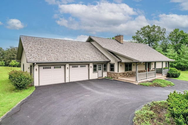 902 S Cedar Grove Blvd, Columbia, MO 65201 - view of front facade featuring driveway, an attached garage, a chimney, a porch, and a shingled roof