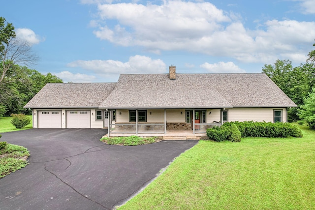 902 S Cedar Grove Blvd, Columbia, MO 65201 - view of front of house featuring a porch, a chimney, asphalt driveway, a garage, and a front lawn