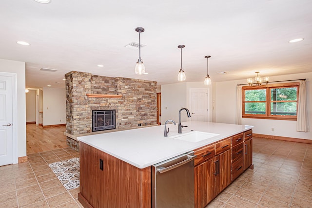 902 S Cedar Grove Blvd, Columbia, MO 65201 - kitchen featuring dishwasher, light tile patterned floors, brown cabinets, light countertops, and a fireplace