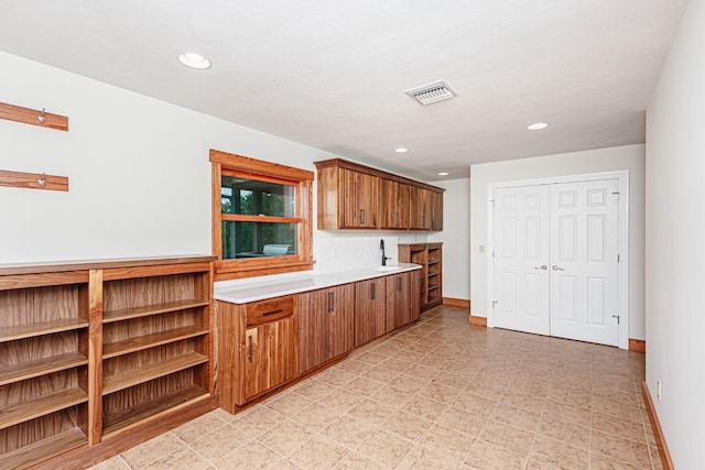 902 S Cedar Grove Blvd, Columbia, MO 65201 - kitchen featuring light countertops, brown cabinetry, and recessed lighting