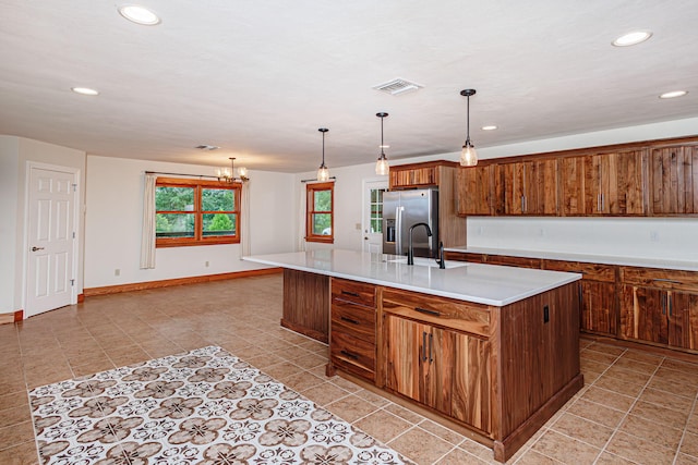 902 S Cedar Grove Blvd, Columbia, MO 65201 - kitchen with stainless steel refrigerator with ice dispenser, an island with sink, light countertops, recessed lighting, and brown cabinets