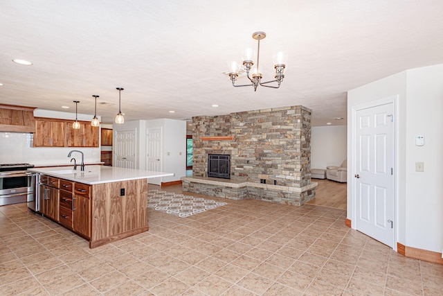 902 S Cedar Grove Blvd, Columbia, MO 65201 - kitchen featuring gas range, open floor plan, light countertops, recessed lighting, and an island with sink