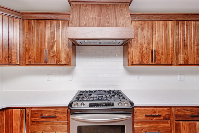 902 S Cedar Grove Blvd, Columbia, MO 65201 - kitchen featuring stainless steel gas range, exhaust hood, brown cabinetry, and backsplash