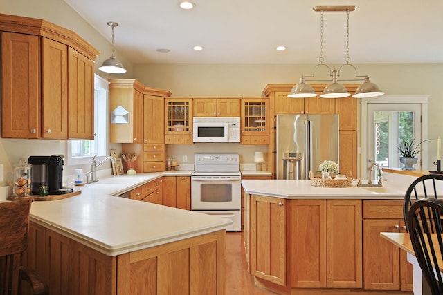 5200 N Locust Grove Church Rd, Columbia, MO 65202 - kitchen with white appliances, a peninsula, light countertops, glass insert cabinets, and hanging light fixtures