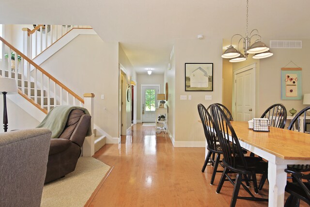 5200 N Locust Grove Church Rd, Columbia, MO 65202 - dining space featuring stairs, a chandelier, and light wood finished floors