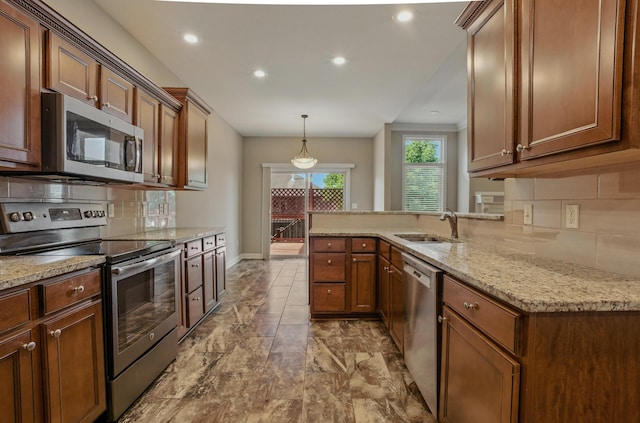 3904 Ivanhoe Blvd, Columbia, MO 65203 - kitchen featuring stainless steel appliances, backsplash, recessed lighting, a peninsula, and light stone counters