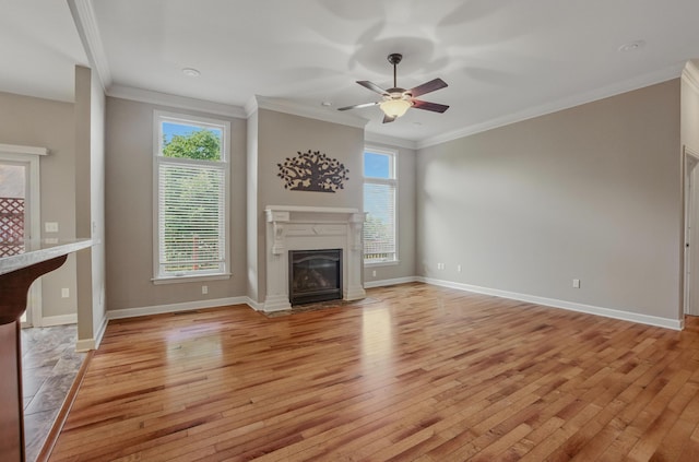 3904 Ivanhoe Blvd, Columbia, MO 65203 - unfurnished living room featuring light wood-type flooring, plenty of natural light, a ceiling fan, a fireplace with flush hearth, and ornamental molding