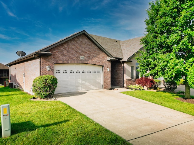 3904 Ivanhoe Blvd, Columbia, MO 65203 - traditional home featuring brick siding, a garage, concrete driveway, and a front lawn