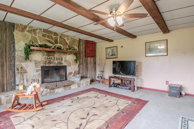 3674 State Road Aa, Holts Summit, MO 65043 - living area with beamed ceiling, carpet flooring, a stone fireplace, and ceiling fan