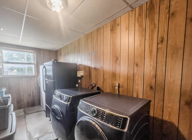 3674 State Road Aa, Holts Summit, MO 65043 - washroom with wooden walls and washing machine and clothes dryer