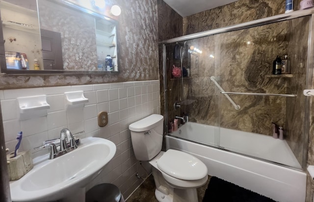 3674 State Road Aa, Holts Summit, MO 65043 - full bathroom featuring bath / shower combo with glass door, tile walls, and a wainscoted wall