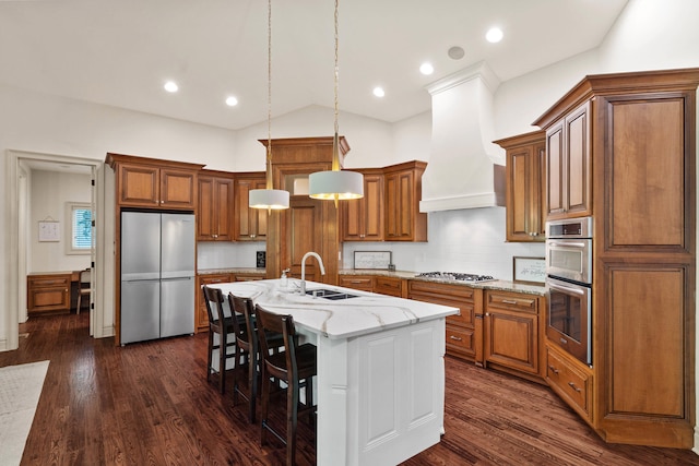 5809 Morning Star Ct, Columbia, MO 65203 - kitchen with appliances with stainless steel finishes, brown cabinets, light stone countertops, a kitchen island with sink, and a kitchen breakfast bar