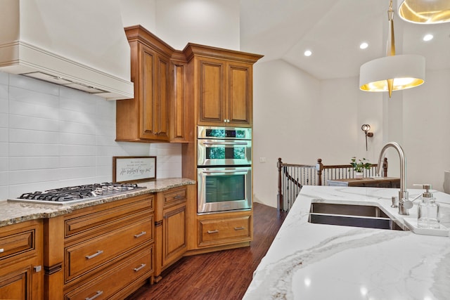 5809 Morning Star Ct, Columbia, MO 65203 - kitchen with premium range hood, appliances with stainless steel finishes, backsplash, brown cabinetry, and dark wood-style floors