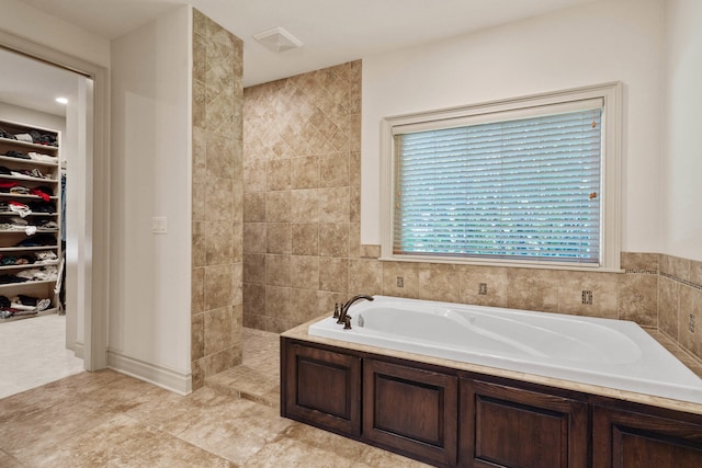 5809 Morning Star Ct, Columbia, MO 65203 - bathroom with a bath, a walk in closet, and tiled shower