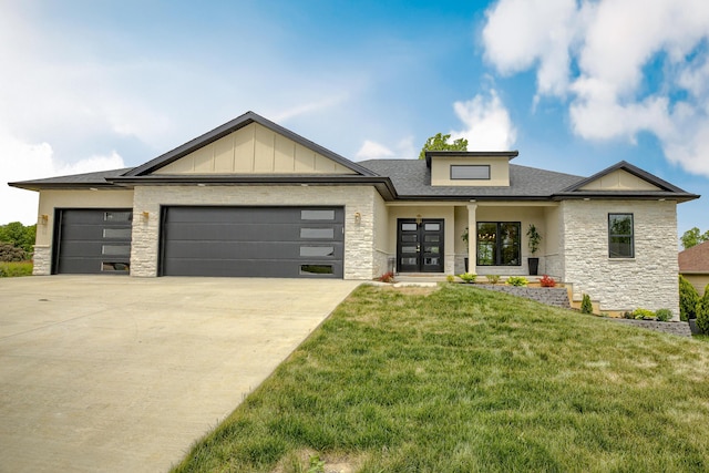 4305 Peregrine Pl, Columbia, MO 65202 - view of front of home featuring stone siding, french doors, a garage, and driveway