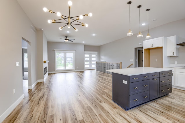 4305 Peregrine Pl, Columbia, MO 65202 - kitchen featuring white cabinets, light wood finished floors, a chandelier, and light countertops