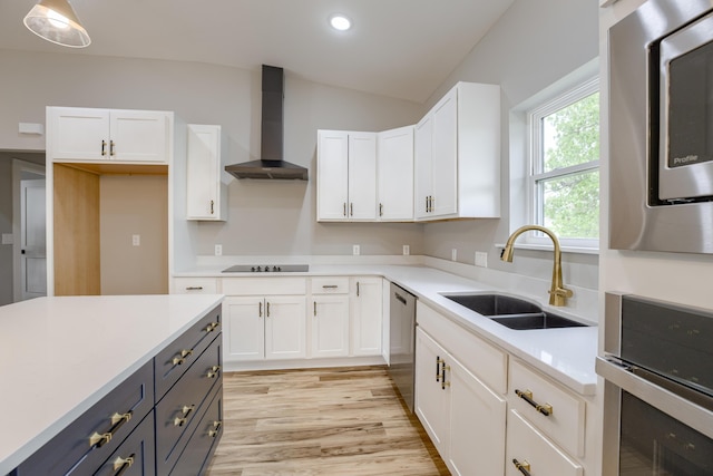 4305 Peregrine Pl, Columbia, MO 65202 - kitchen with wall chimney range hood, white cabinetry, appliances with stainless steel finishes, vaulted ceiling, and light countertops