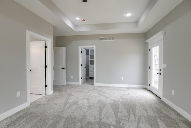 4305 Peregrine Pl, Columbia, MO 65202 - unfurnished bedroom featuring light colored carpet, a raised ceiling, a walk in closet, and recessed lighting