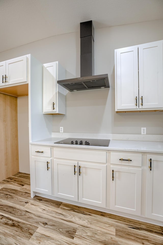 4305 Peregrine Pl, Columbia, MO 65202 - kitchen featuring wall chimney range hood, black electric stovetop, white cabinetry, light wood-style flooring, and light countertops