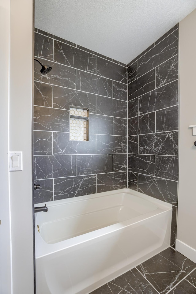 4305 Peregrine Pl, Columbia, MO 65202 - bathroom featuring marble look tile flooring, tile walls, shower / bath combination, and a textured ceiling