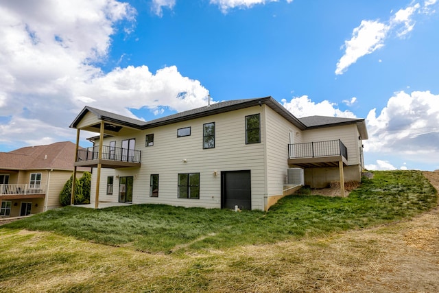 4305 Peregrine Pl, Columbia, MO 65202 - back of house with a balcony, a yard, and a garage