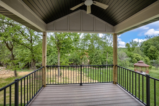 4305 Peregrine Pl, Columbia, MO 65202 - wooden terrace featuring ceiling fan, a gazebo, view of wooded area, and a lawn