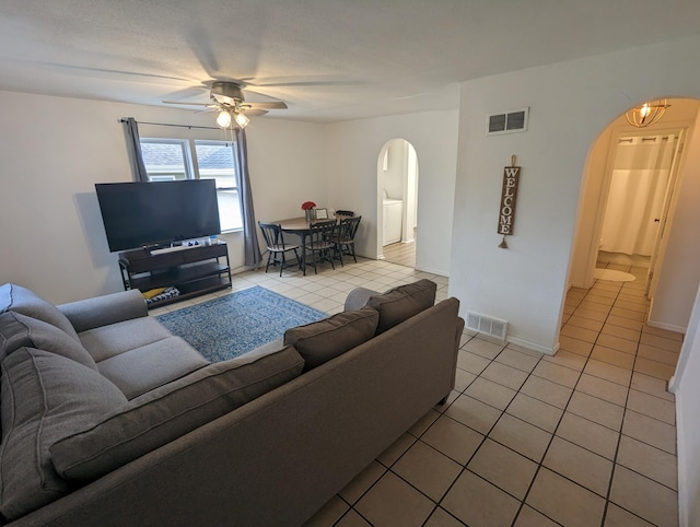 505 W Worley St, Columbia, MO 65203 - living area with arched walkways, light tile patterned floors, and a ceiling fan