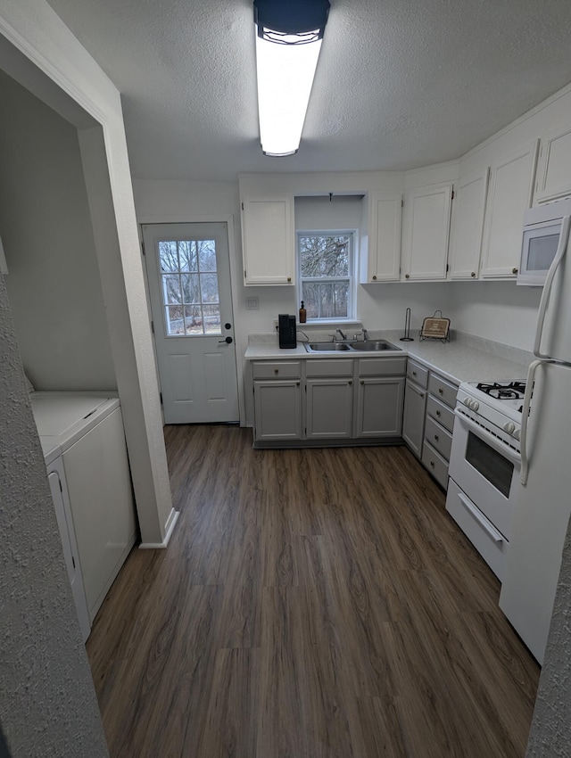 505 W Worley St, Columbia, MO 65203 - kitchen featuring white appliances, white cabinets, dark wood-style floors, light countertops, and a textured ceiling